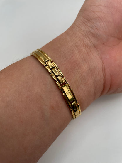 Rear wrist shot showing the gold bracelet and Givenchy clasp on the Millesime watch