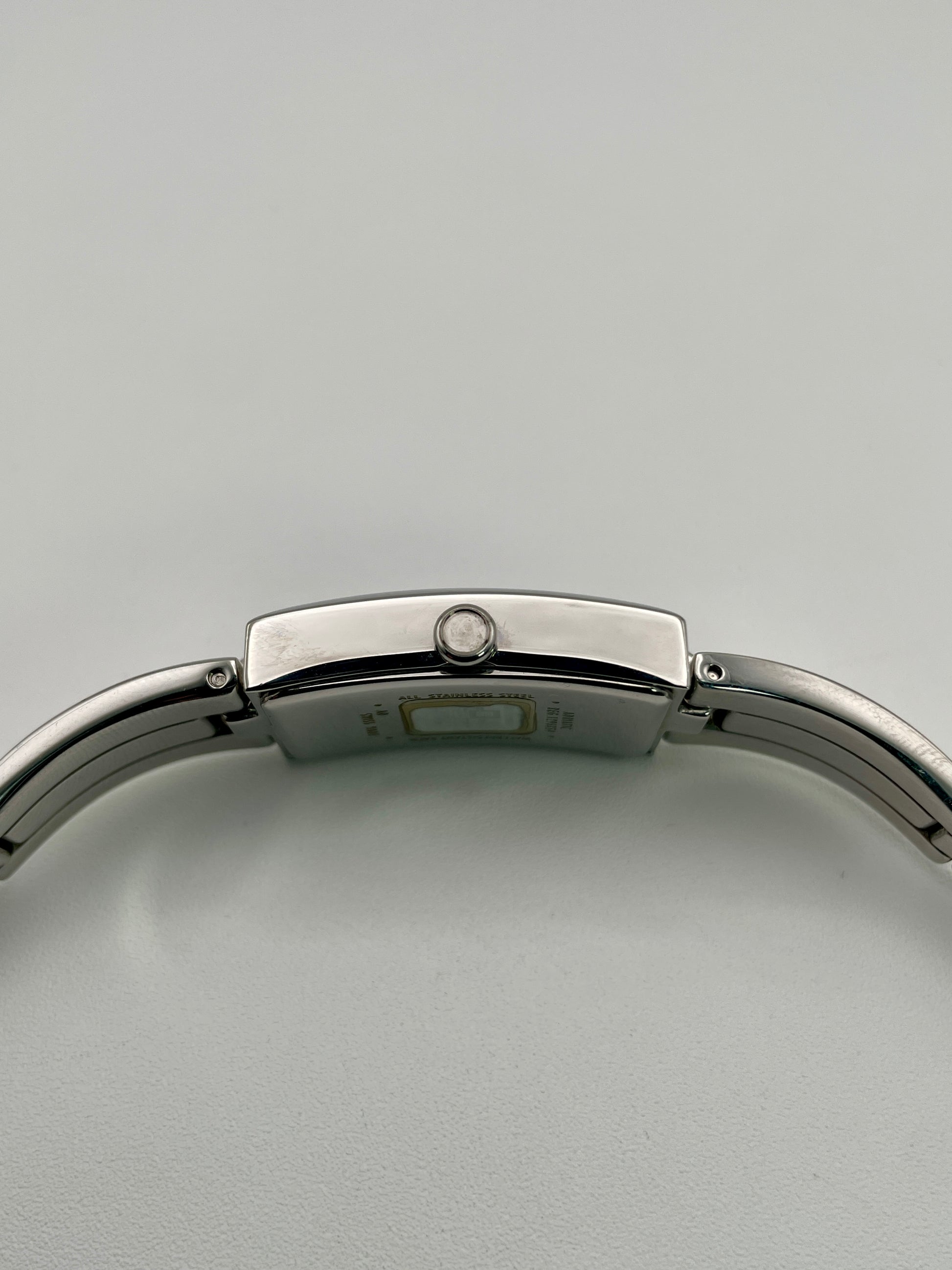 Side view showing the crown of the Givenchy Tank watch and curved case profile
