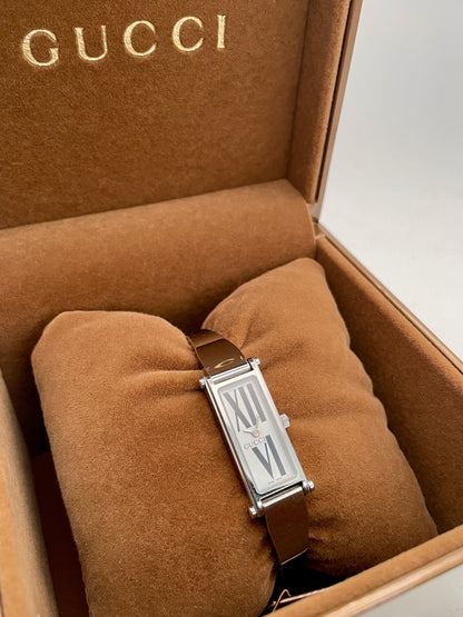 Gucci 1500L white dial watch with a rectangular silver-tone case and stainless steel bracelet, displayed in the original Gucci box.