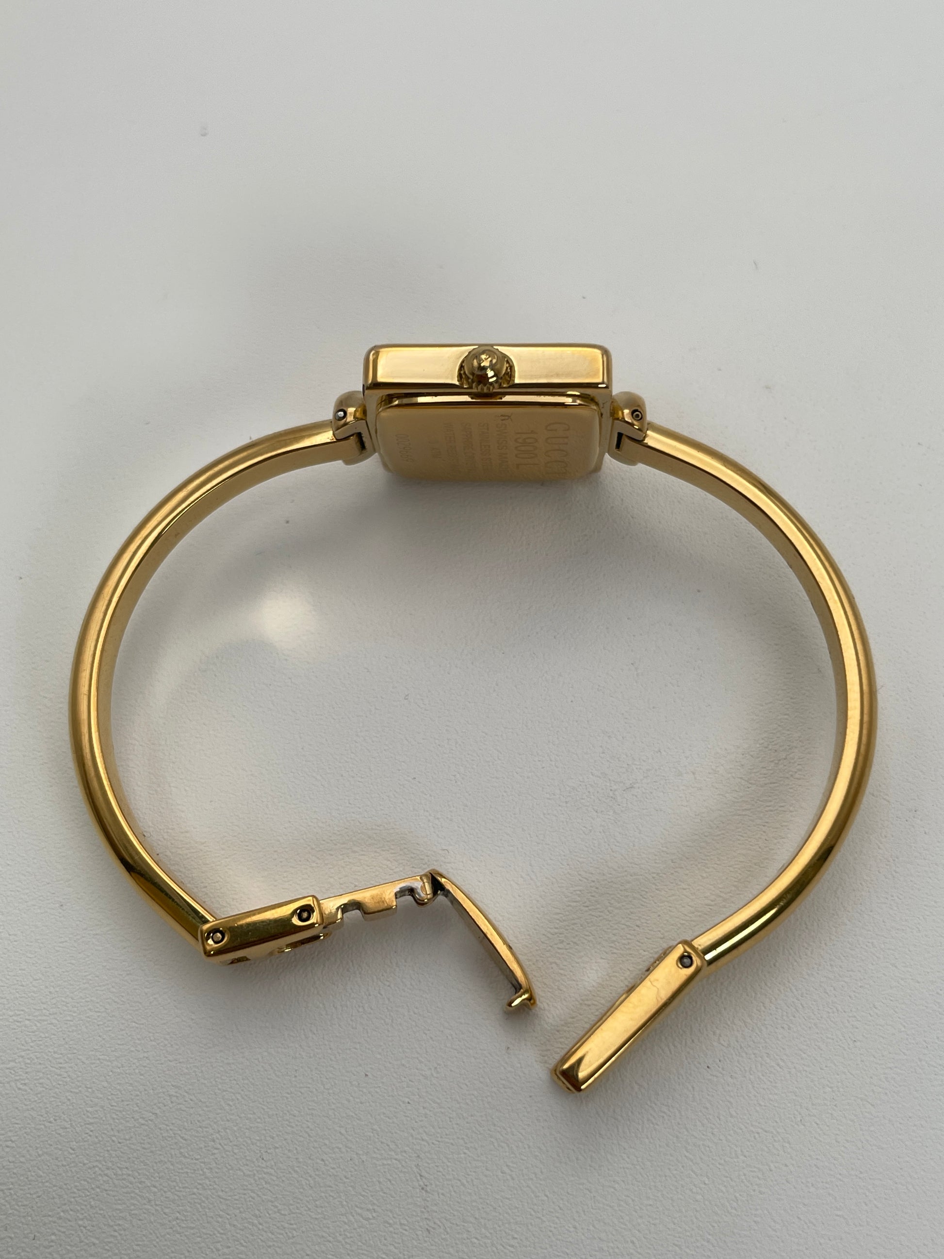 Crown view of Gucci 1900L gold watch highlighting the gold crown and side profile.

