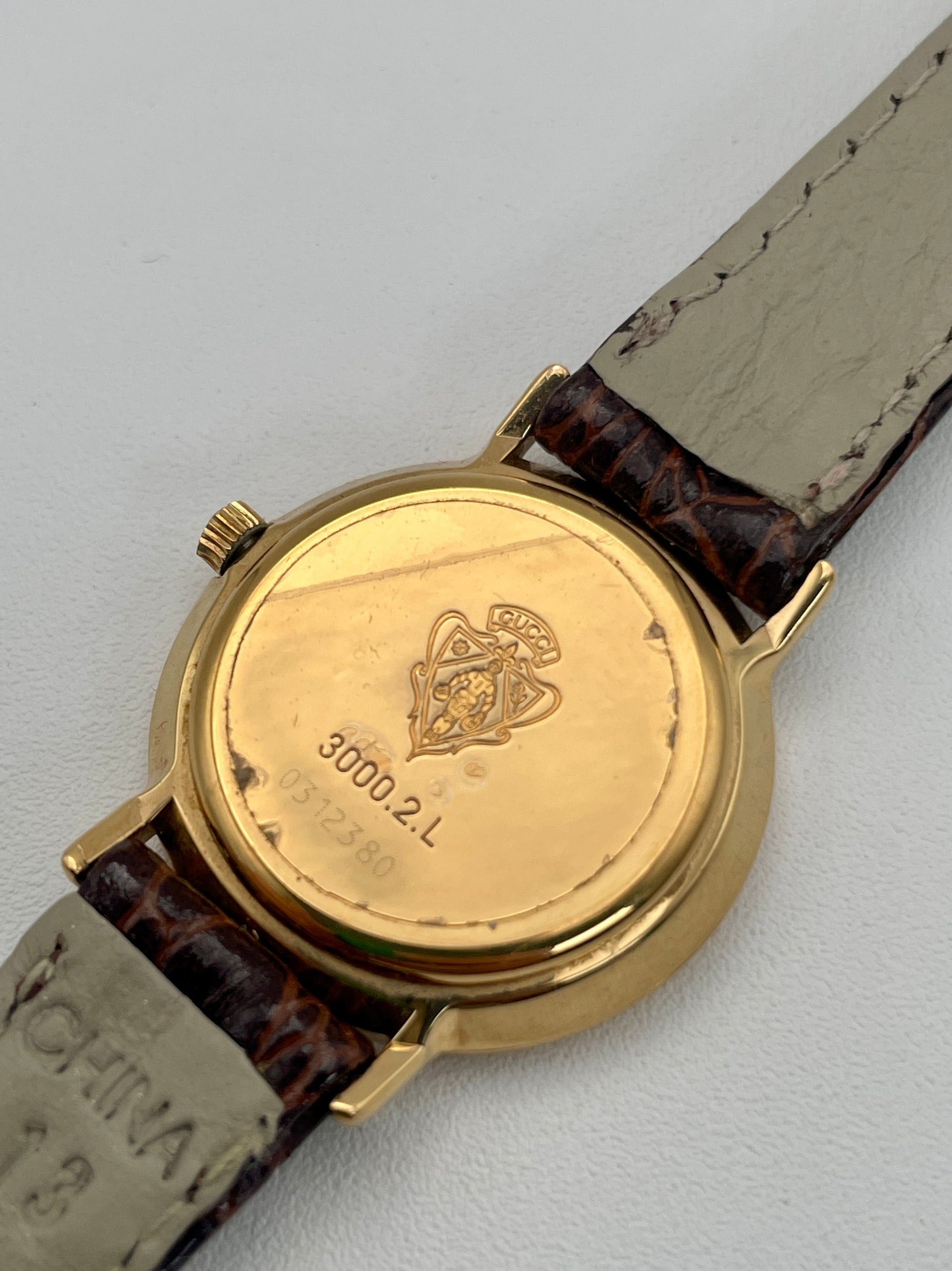 Caseback view of the Gucci 3000.2.L vintage watch showing model and serial number engravings.