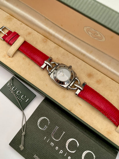 Gucci 6300L ladies' watch featuring a stainless steel square case with rounded edges, white dial, and red lizard skin strap, in its box and comes with tag and papers.
