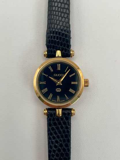 Close-up front view of the Gucci Sherry Line Vintage Women's Watch in gold, displaying the refined black dial and gold detailing.