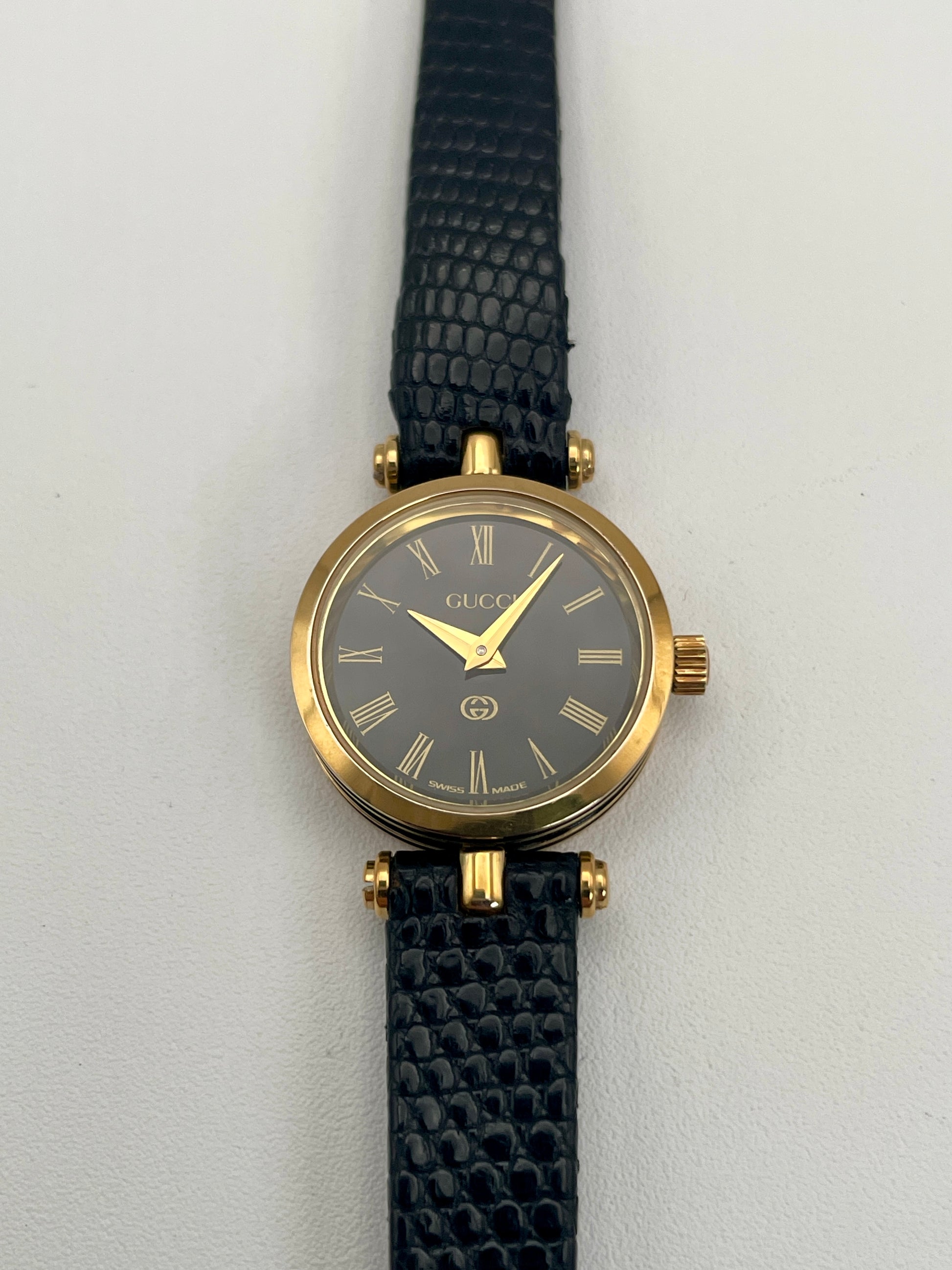 Front view of the Gucci Sherry Line Vintage Women's Watch in gold, showcasing a black dial with Roman numeral hour markers.