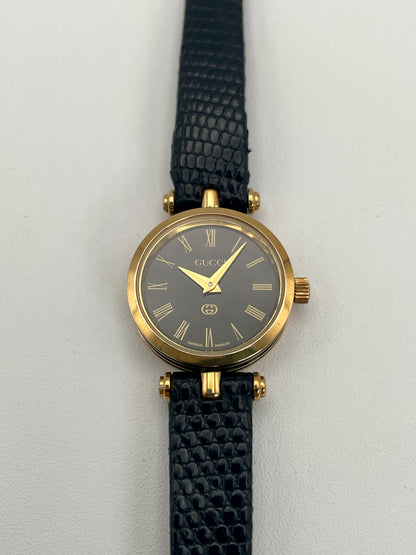 Front view of the Gucci Sherry Line Vintage Women's Watch in gold, showcasing a black dial with Roman numeral hour markers.