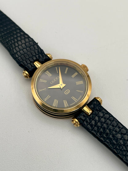 Main view of the Gucci Sherry Line Vintage Women's Watch in gold, showcasing a black dial with Roman numeral hour markers.