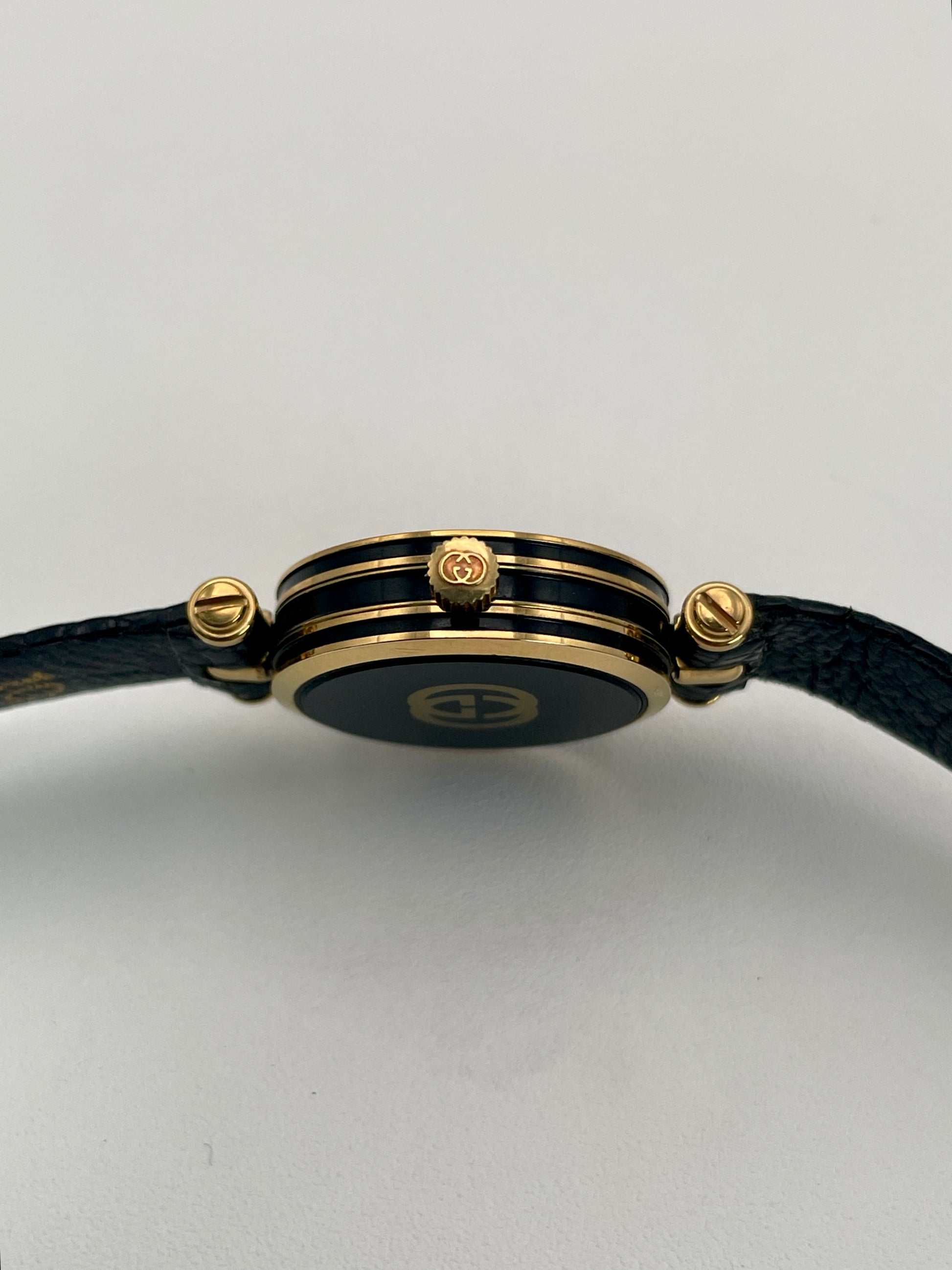 Side profile of the Gucci Sherry Line Vintage Women's Watch in gold, showcasing the dual-layered case and logo-embossed crown.