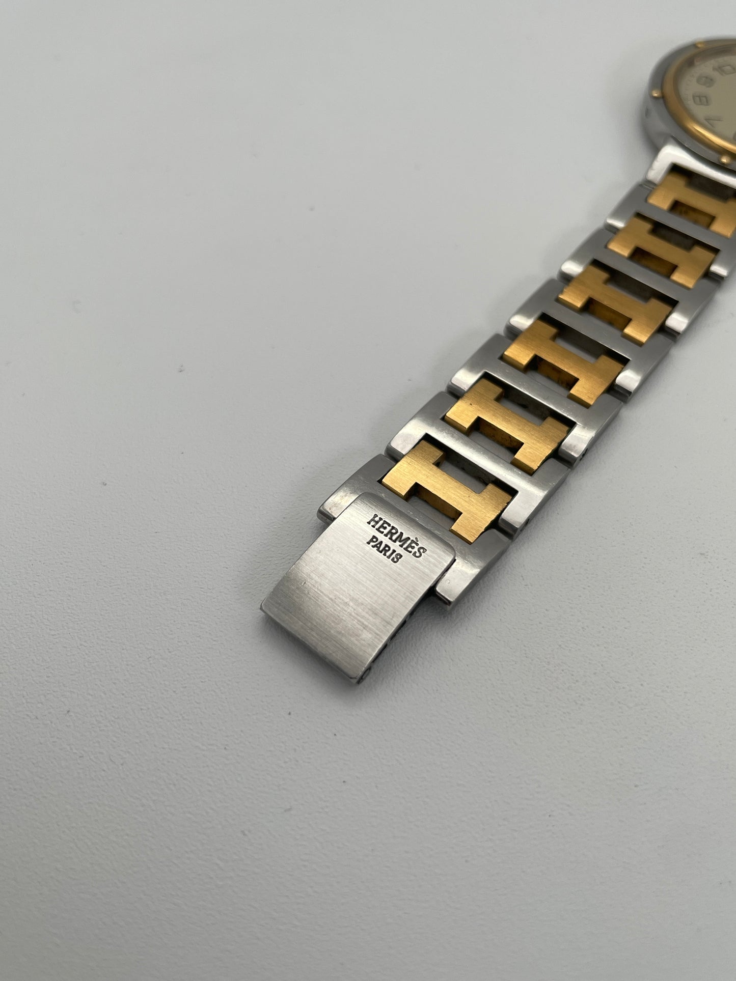 Buckle view of Hermes Clipper Men's 35mm watch focusing on the two-tone iconic H style bracelet with Hermes Paris branding.