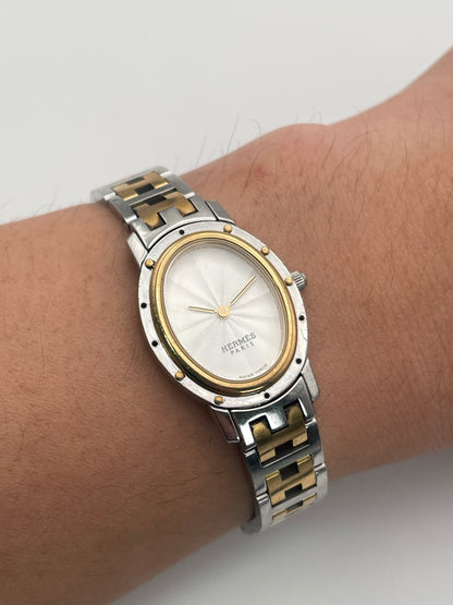 Wrist shot of the Hermès Clipper Oval Ladies Watch showcasing its elegant two-tone bracelet and oval case.