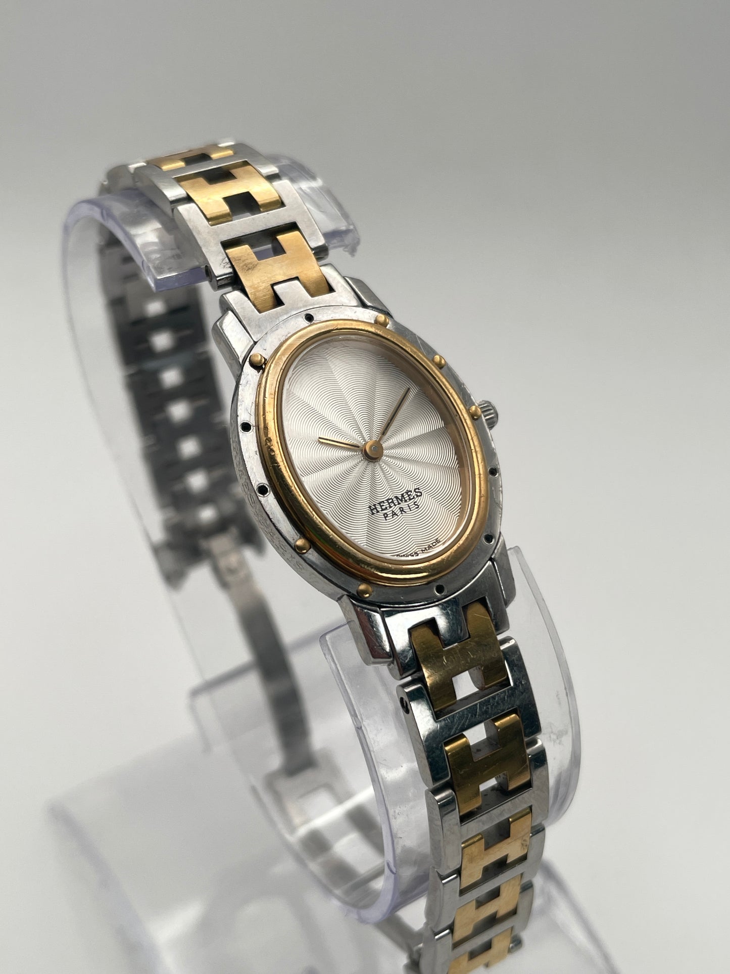 Hermès Clipper Oval Vintage Ladies Watch in two-tone stainless steel with gold accents, featuring a silver guilloché dial.