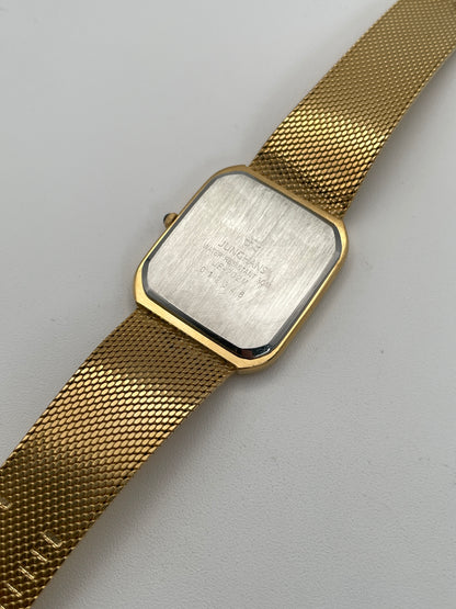 Caseback view of Junghans Excellent vintage quartz watch showing the gold-tone bracelet and stainless steel caseback.