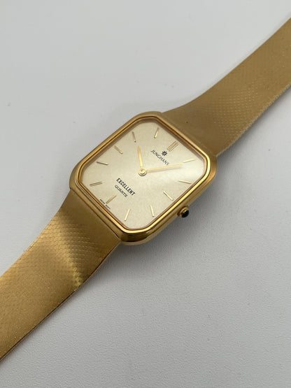 Diagonal view of Junghans Excellent vintage quartz watch with a gold-tone square case, gold-tone dial, and matching gold-tone bracelet.