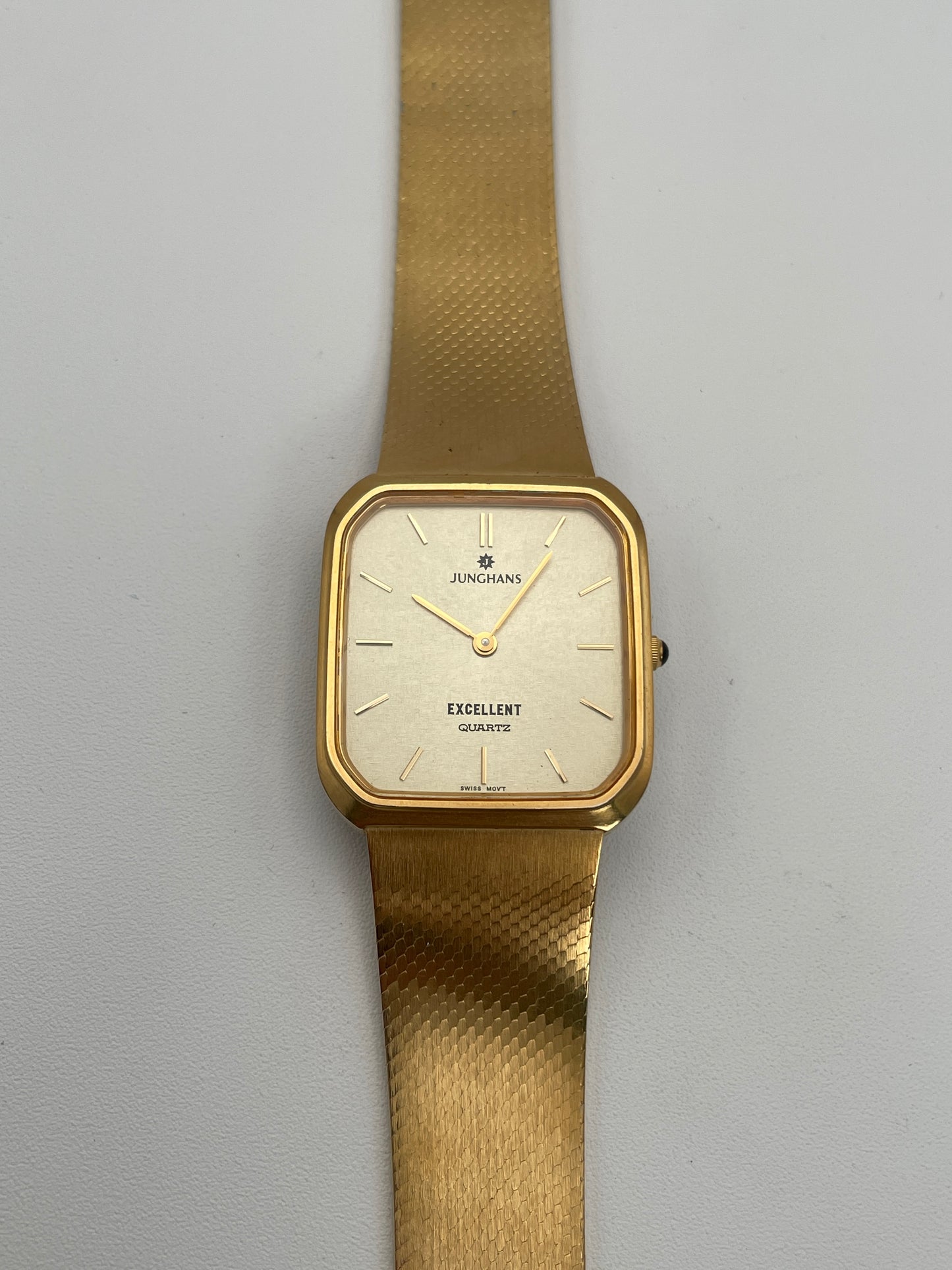 Front view of Junghans Excellent vintage quartz watch with a gold-tone square case, gold-tone dial, and matching gold-tone bracelet.