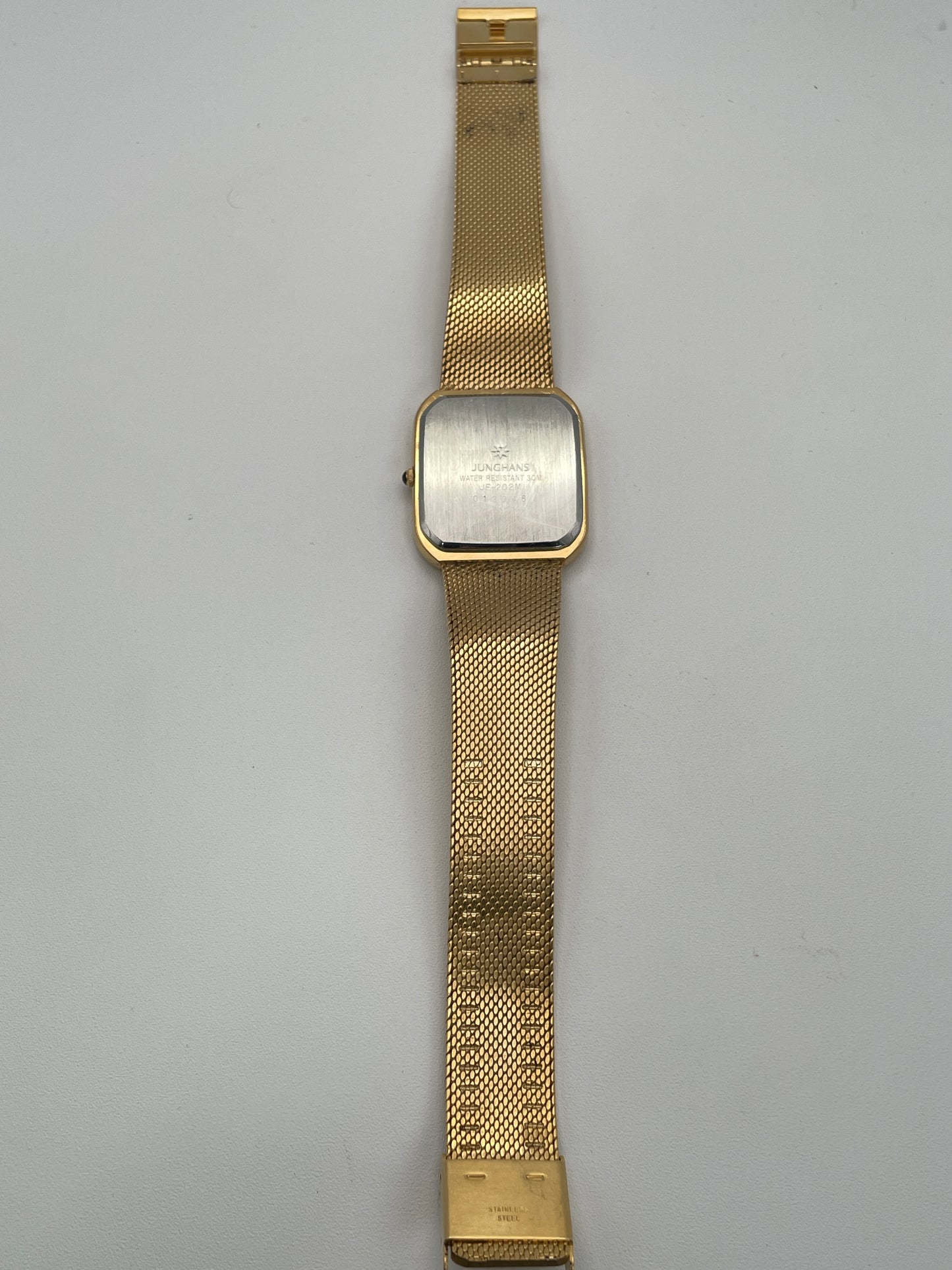 Full view of Junghans Excellent vintage quartz watch displaying the gold-tone square case and mesh-style bracelet.