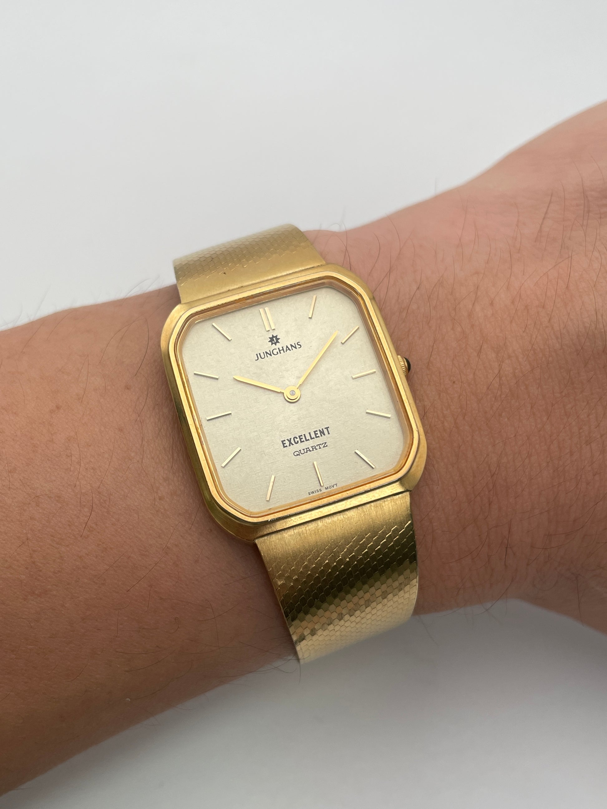 Wrist shot view of Junghans Excellent vintage quartz watch with a gold-tone square case and matching gold-tone bracelet.