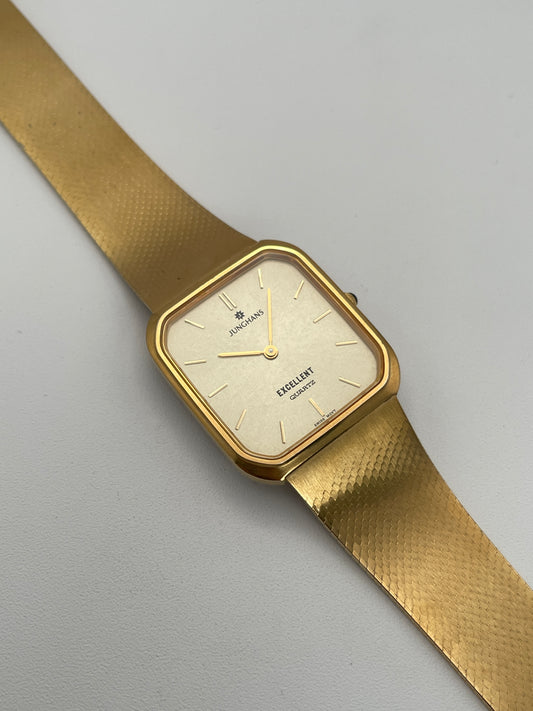 Junghans Excellent vintage quartz watch with a gold-tone square case, gold-tone dial, and matching gold-tone bracelet.