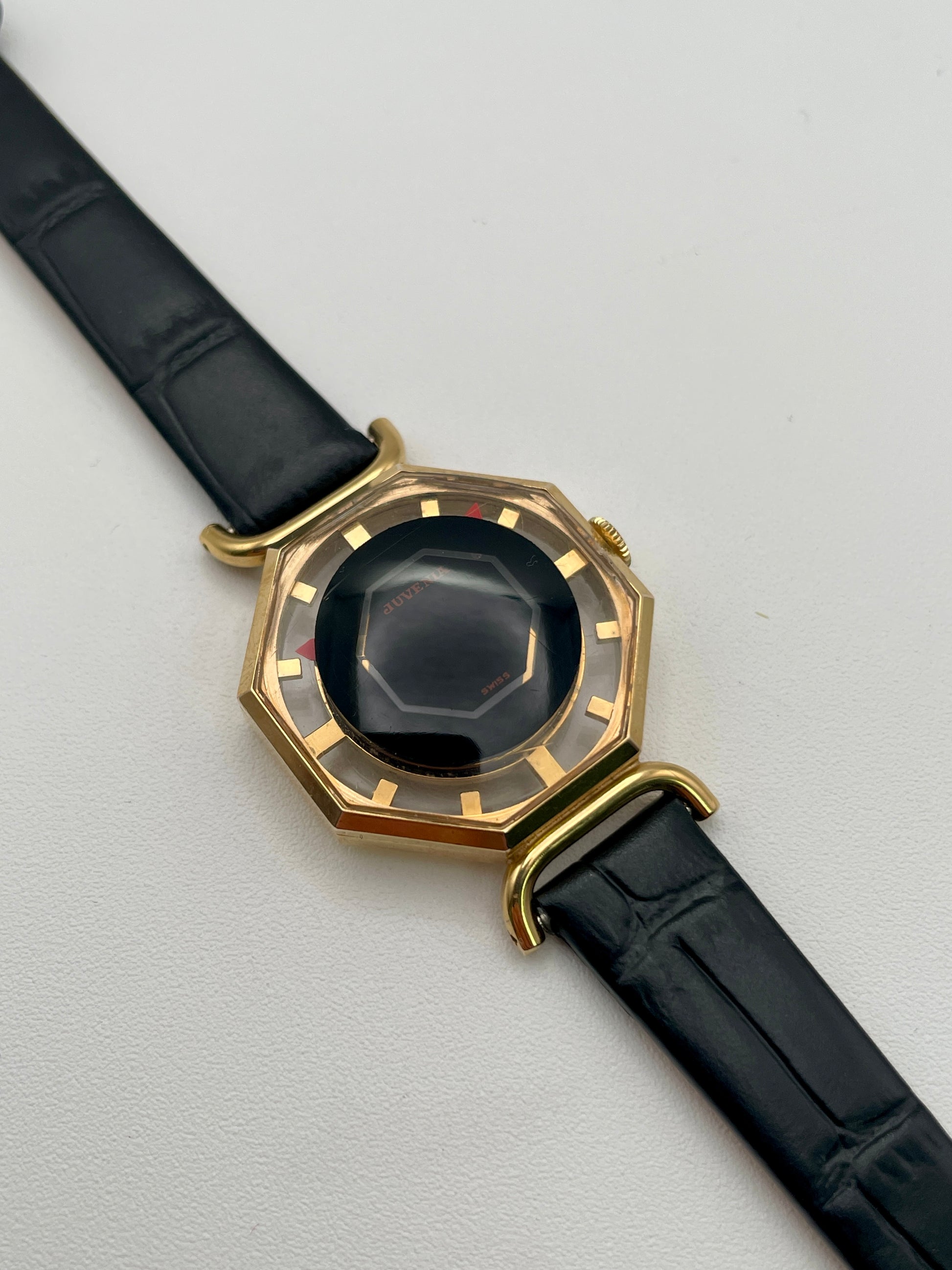Diagonal view from left showing faceted crystal and octagonal case of Juvenia Octagion watch
