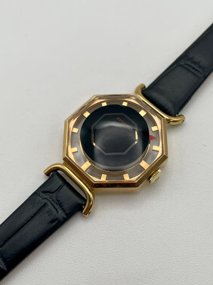 Diagonal view from right highlighting the gold-tone case and black dial of the Juvenia Octagion
