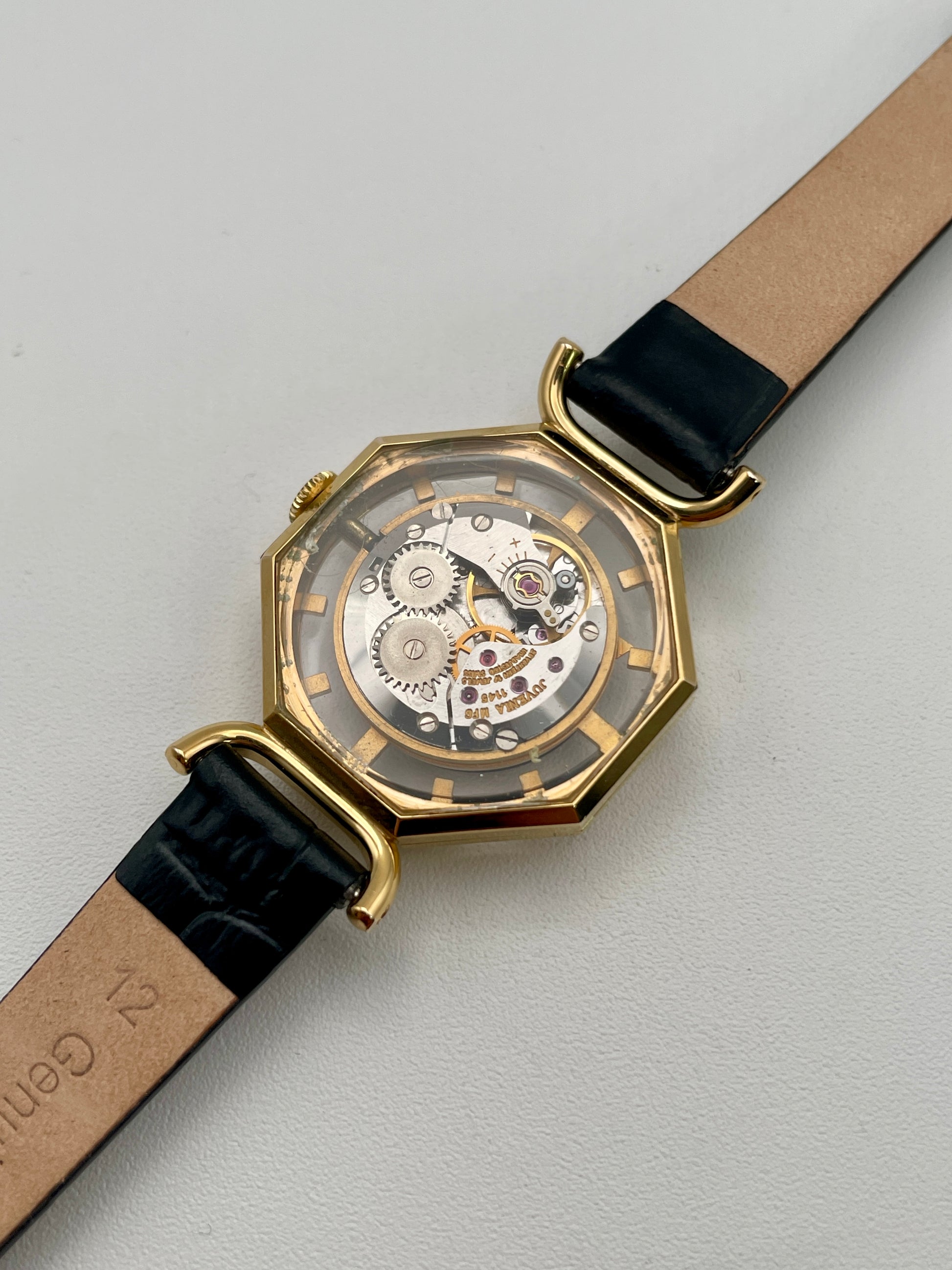 View of Juvenia Octagion's mechanical movement through clear exhibition caseback
