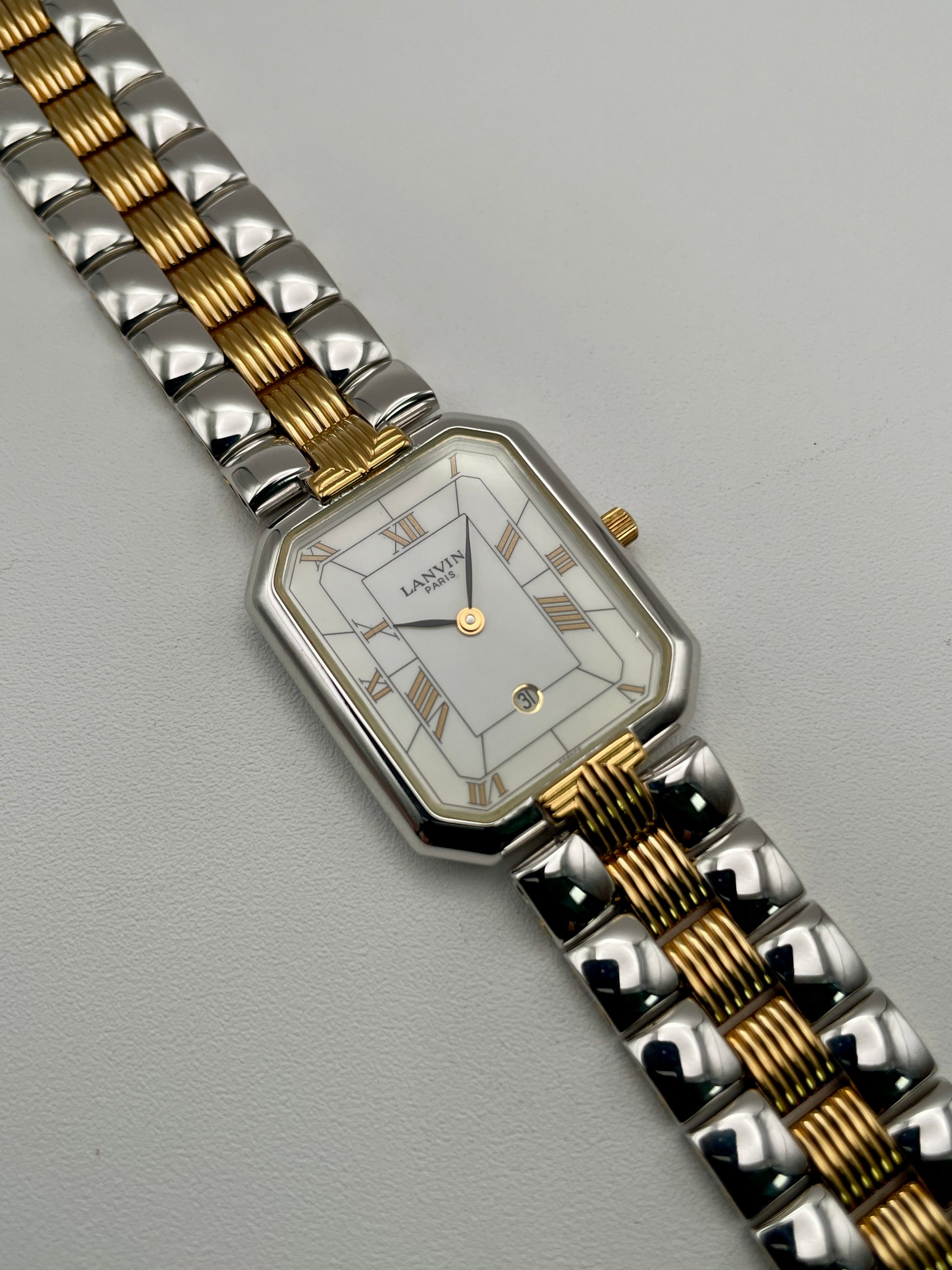 Angled view of Lanvin Paris 516897.B watch showing gold crown and elegant case design
