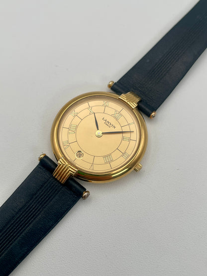 Diagonal view of Lanvin Paris Vintage Gold Watch with Roman numeral dial and black strap
