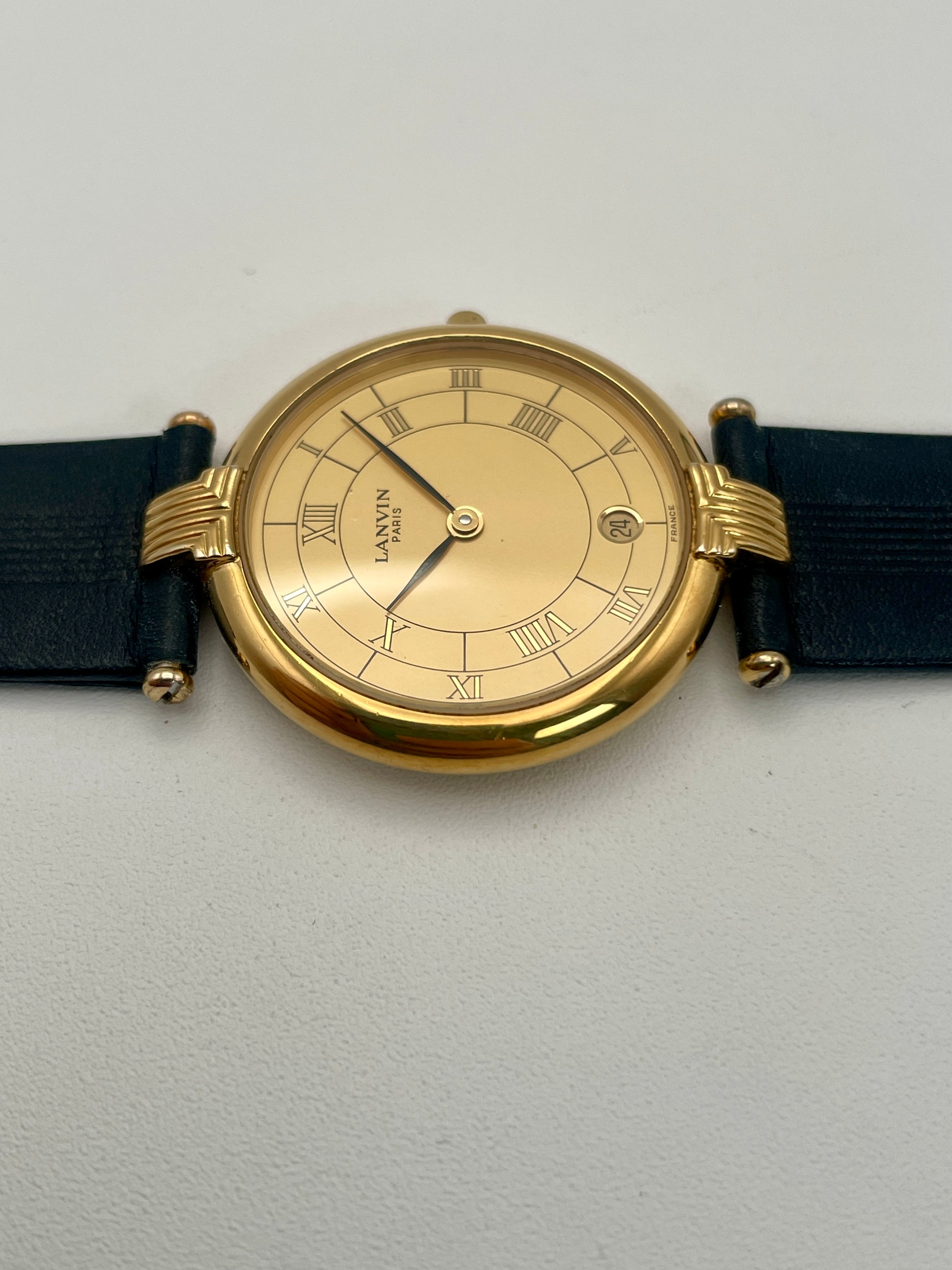 Side view of the thin gold-tone case of the Lanvin Paris Vintage Watch
