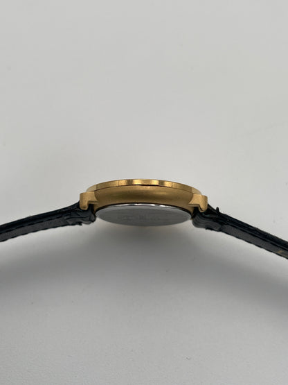 Side profile showcasing the slimness of the gold case and smooth bezel.