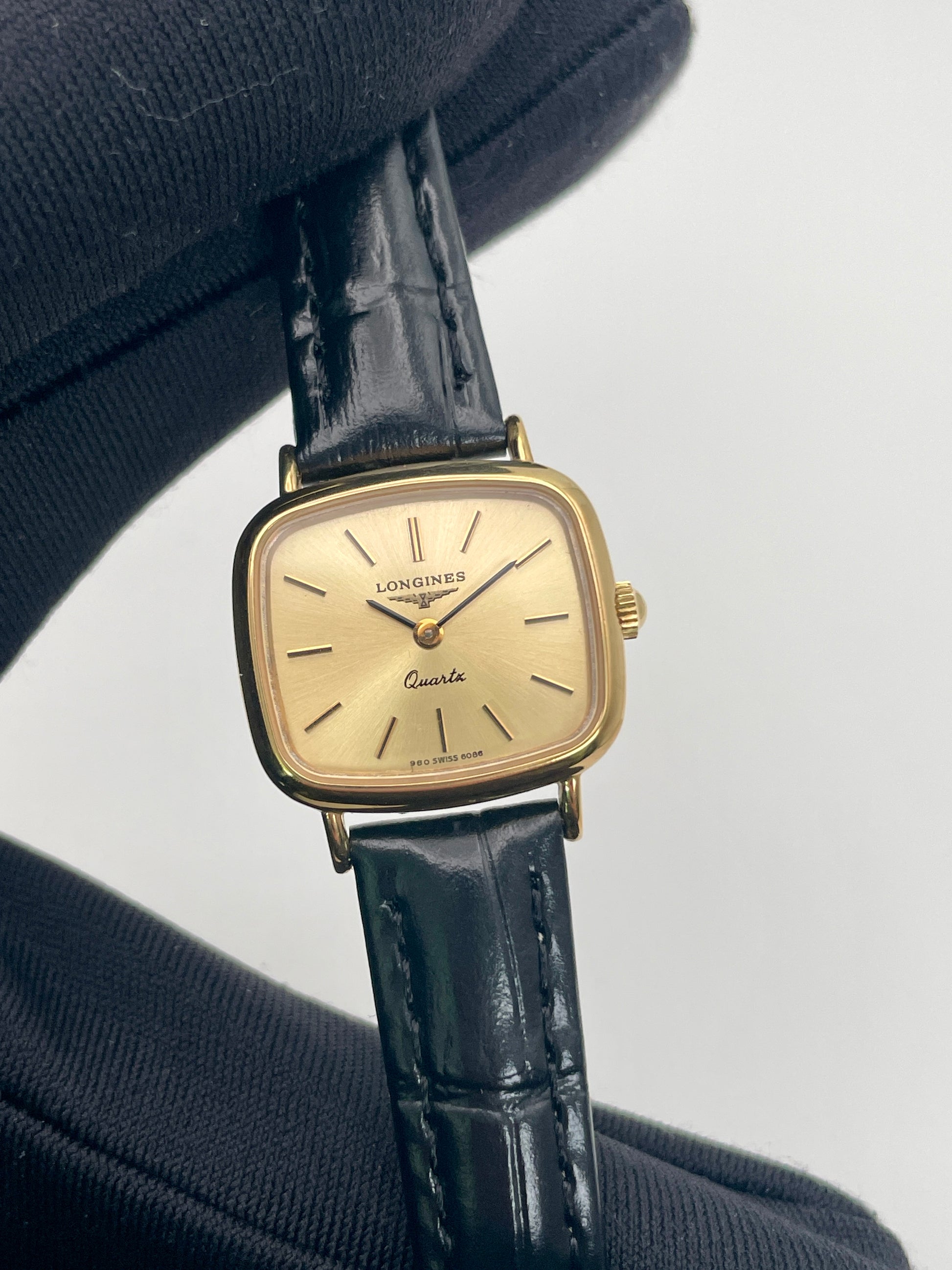Close-up view of Longines 6068.2 watch on black glove, highlighting the rectangular case and clean dial

