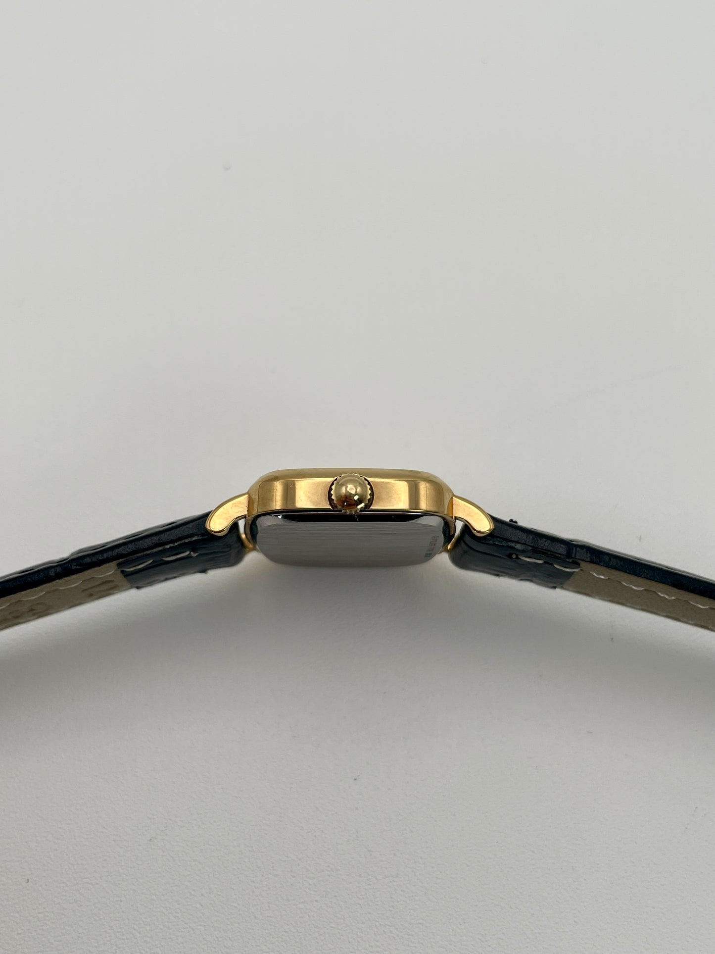 Side view with crown of Longines 6068.2 showcasing gold-tone crown and curved lugs

