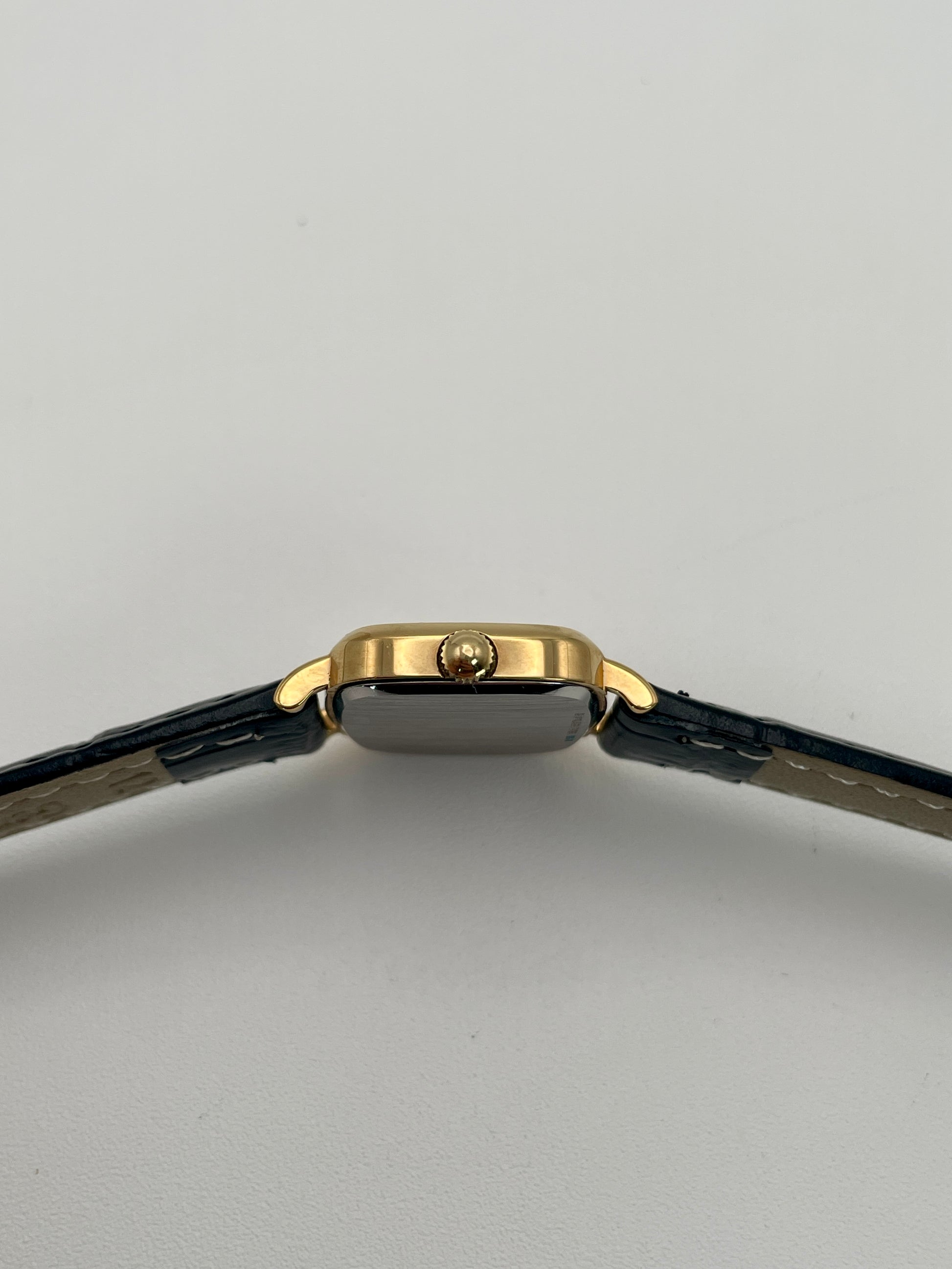Side view with crown of Longines 6068.2 showcasing gold-tone crown and curved lugs
