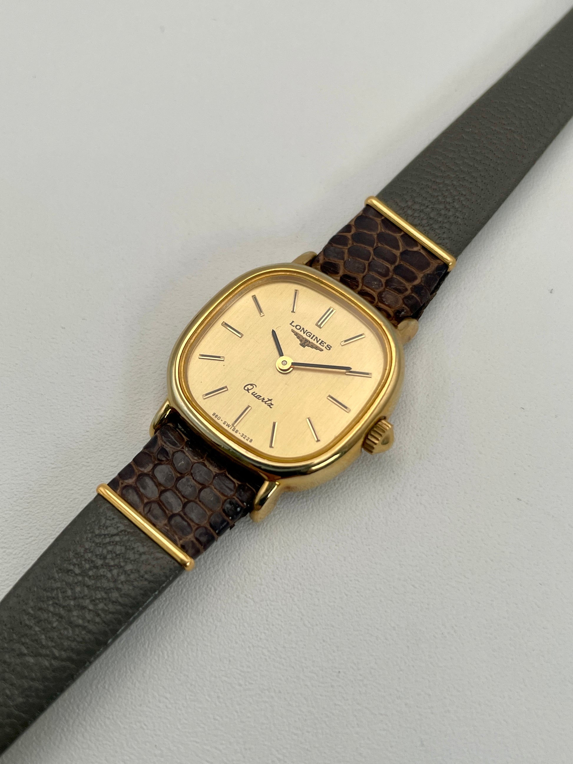 Diagonal view of the Longines 960 vintage women's watch in a gold-tone square case with a gold dial.