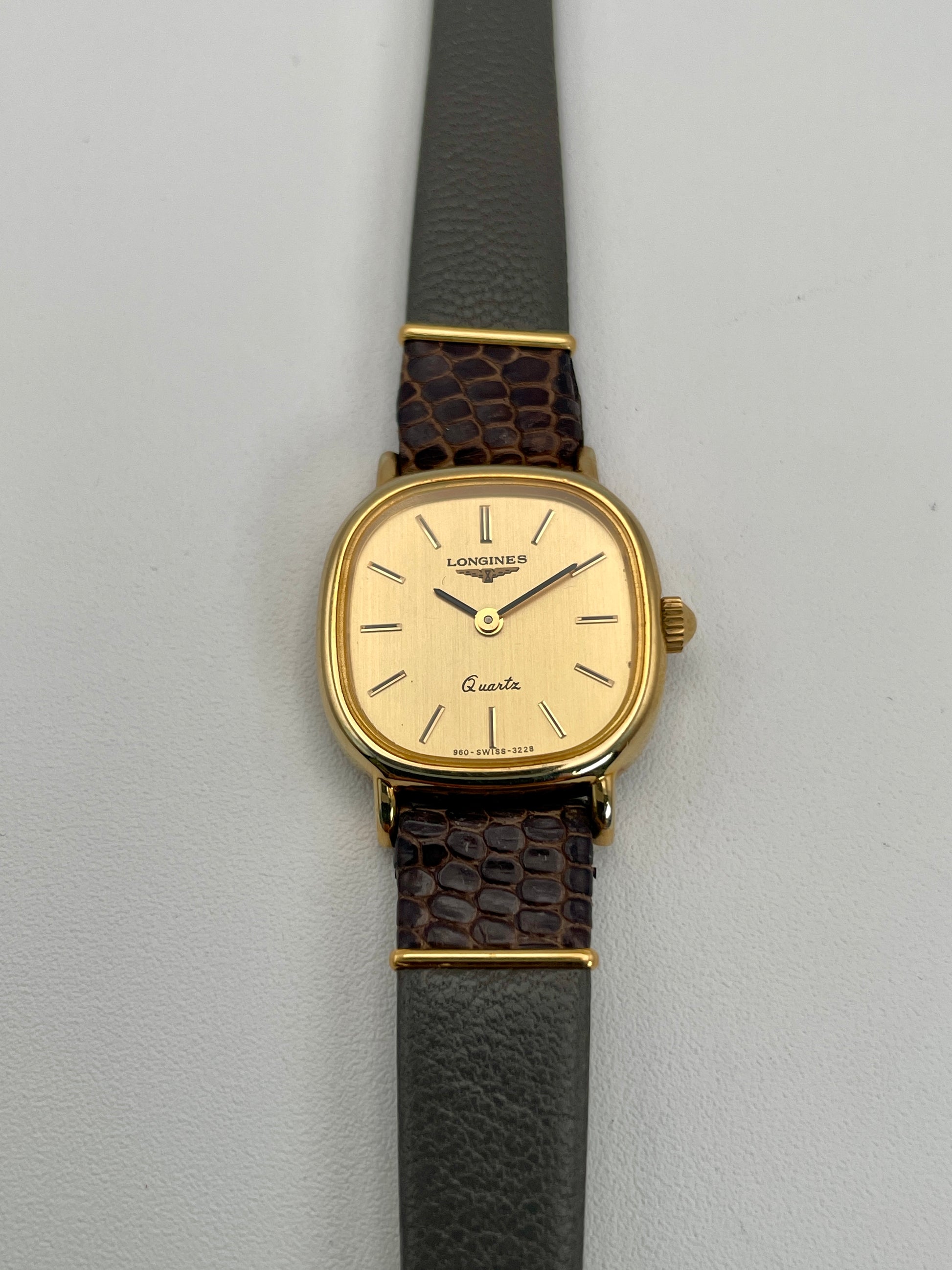 Front view of the Longines 960 vintage women's watch in a gold-tone square case with a gold dial.