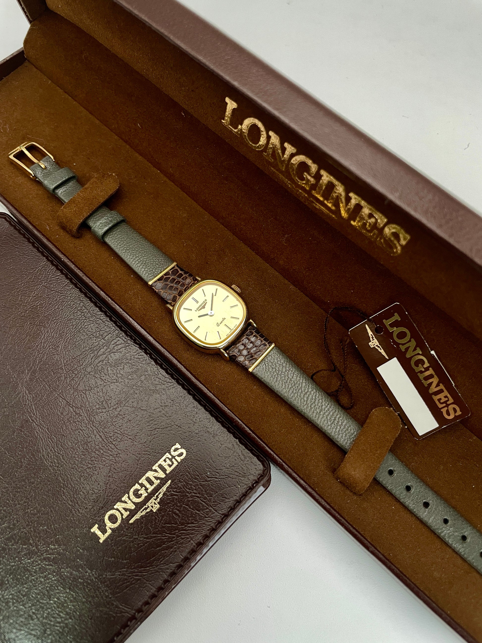 Longines 960 vintage women's gold watch displayed in its original brown box with documentation and tag.