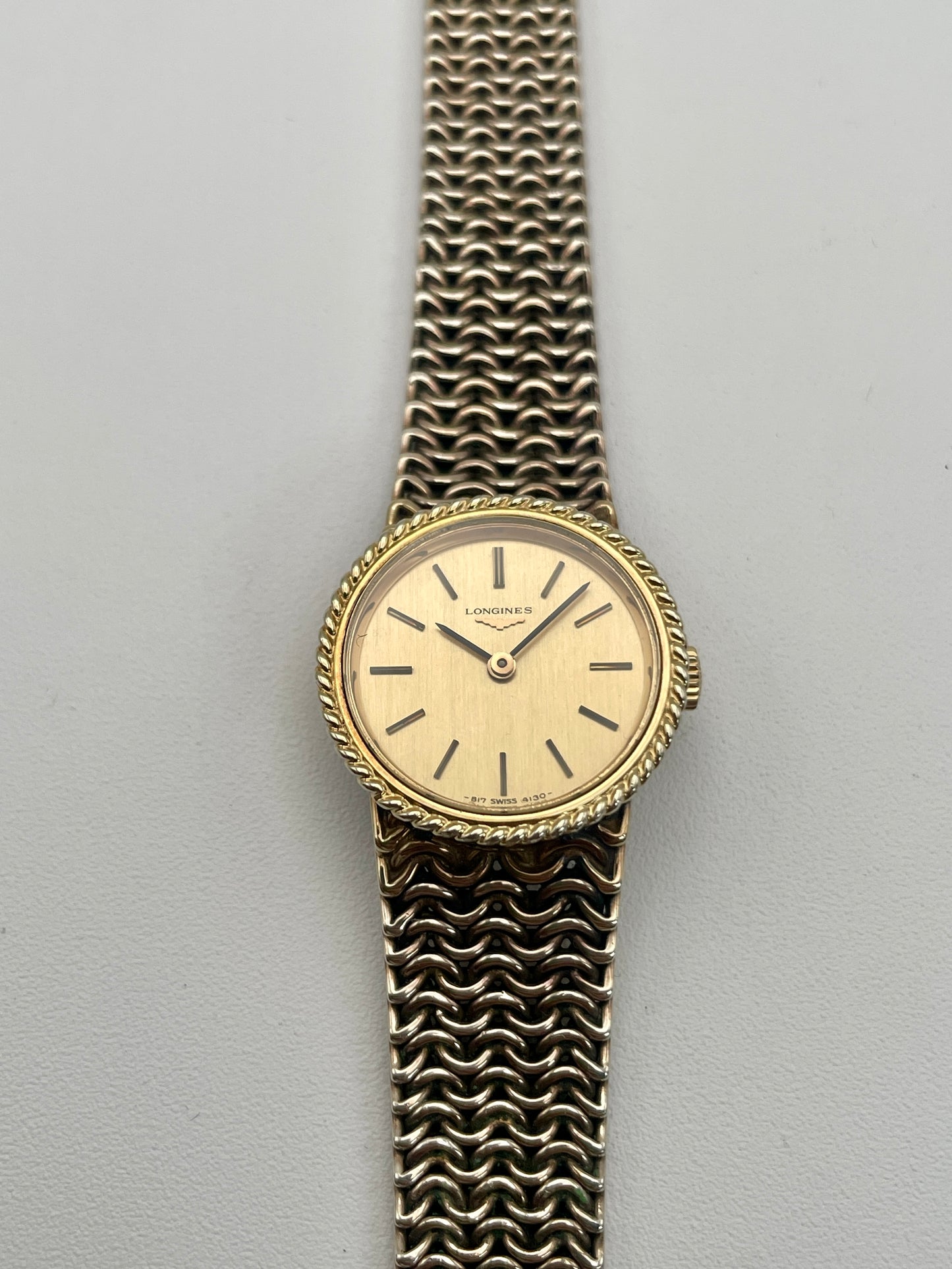 Front view of Longines Braided Bezel Vintage Ladies Watch in gold with a chainmail bracelet.