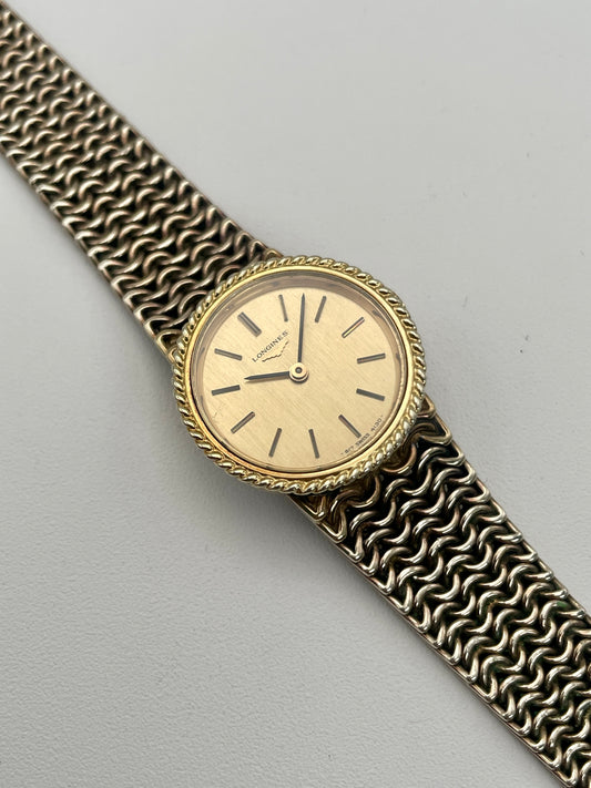 View of Longines Braided Bezel Vintage Ladies Watch in gold with a chainmail bracelet.