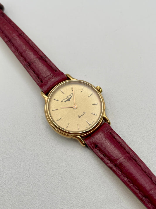 Diagonal left view of Longines L153.4 watch showing gold-tone case and champagne dial
