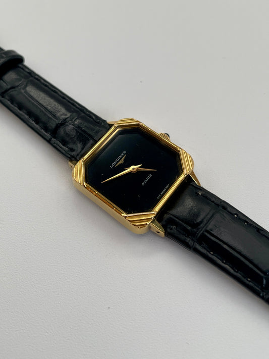 Front view of Longines Neo-Vintage Quartz watch with gold case, black dial, and black leather strap.