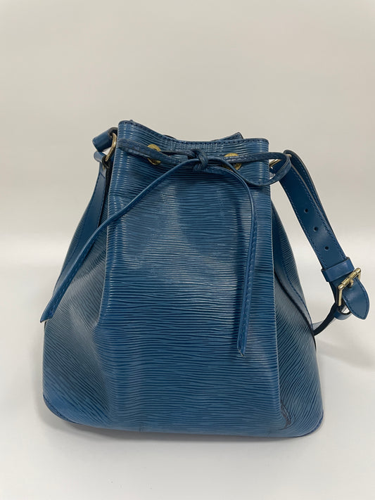 Front view of the Louis Vuitton Petit Noé Shoulder Bag in Toledo Blue leather, showcasing the drawstring closure and structured base.