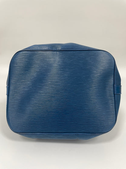 Bottom view of Louis Vuitton Petit Noé Shoulder Bag in Toledo Blue Leather, showcasing the reinforced base and textured leather.