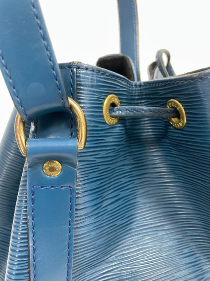 Detailed view of the gold-tone eyelets on the Louis Vuitton Petit Noé Shoulder Bag in Toledo Blue Leather.