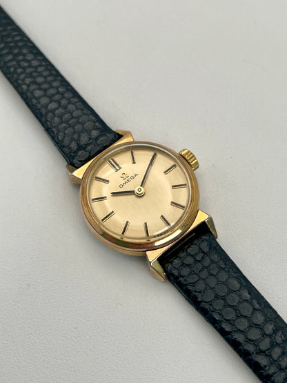 Main view of the Omega Art Deco vintage ladies watch in gold with a black leather strap.