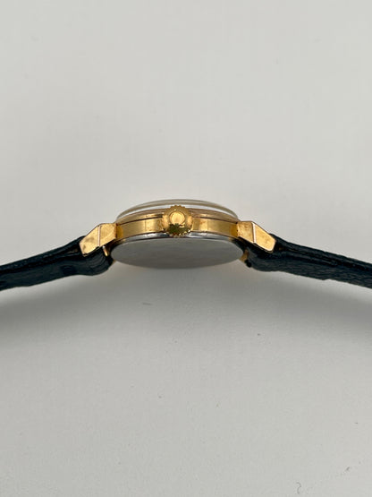 Side view of Omega Art Deco gold ladies watch showcasing the crown and gold case details.