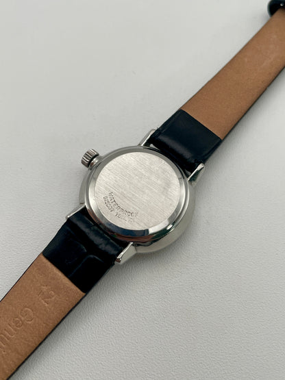 Caseback view of the Omega De Ville 515.007 vintage women's watch, featuring a stainless steel back and black leather strap.