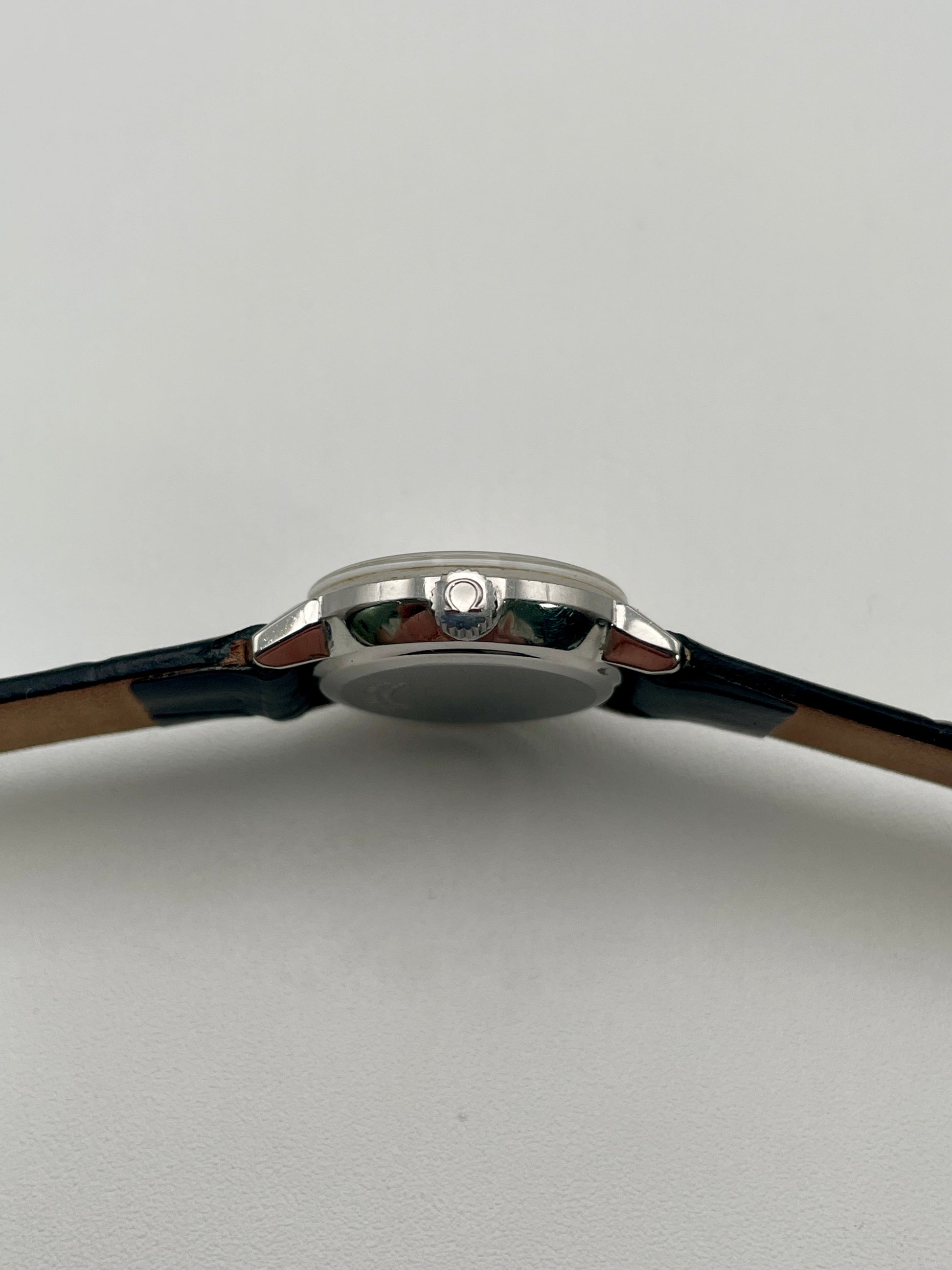 Side view of the Omega De Ville 515.007 vintage women's watch focusing on its polished stainless steel crown and case profile.