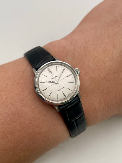 Wrist shot of the Omega De Ville 515.007 vintage women's watch in stainless steel, paired with a black leather strap for an elegant fit.