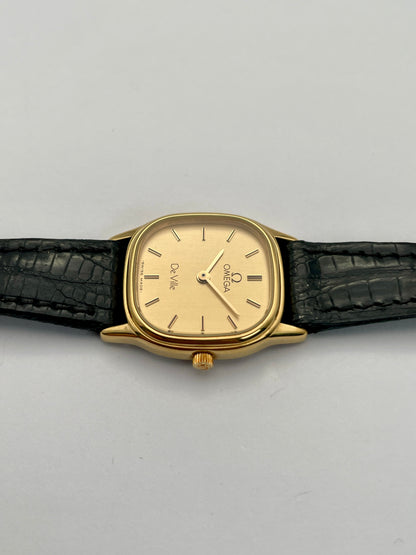 Top crown view of Omega De Ville vintage gold watch highlighting the gold crown and square case.