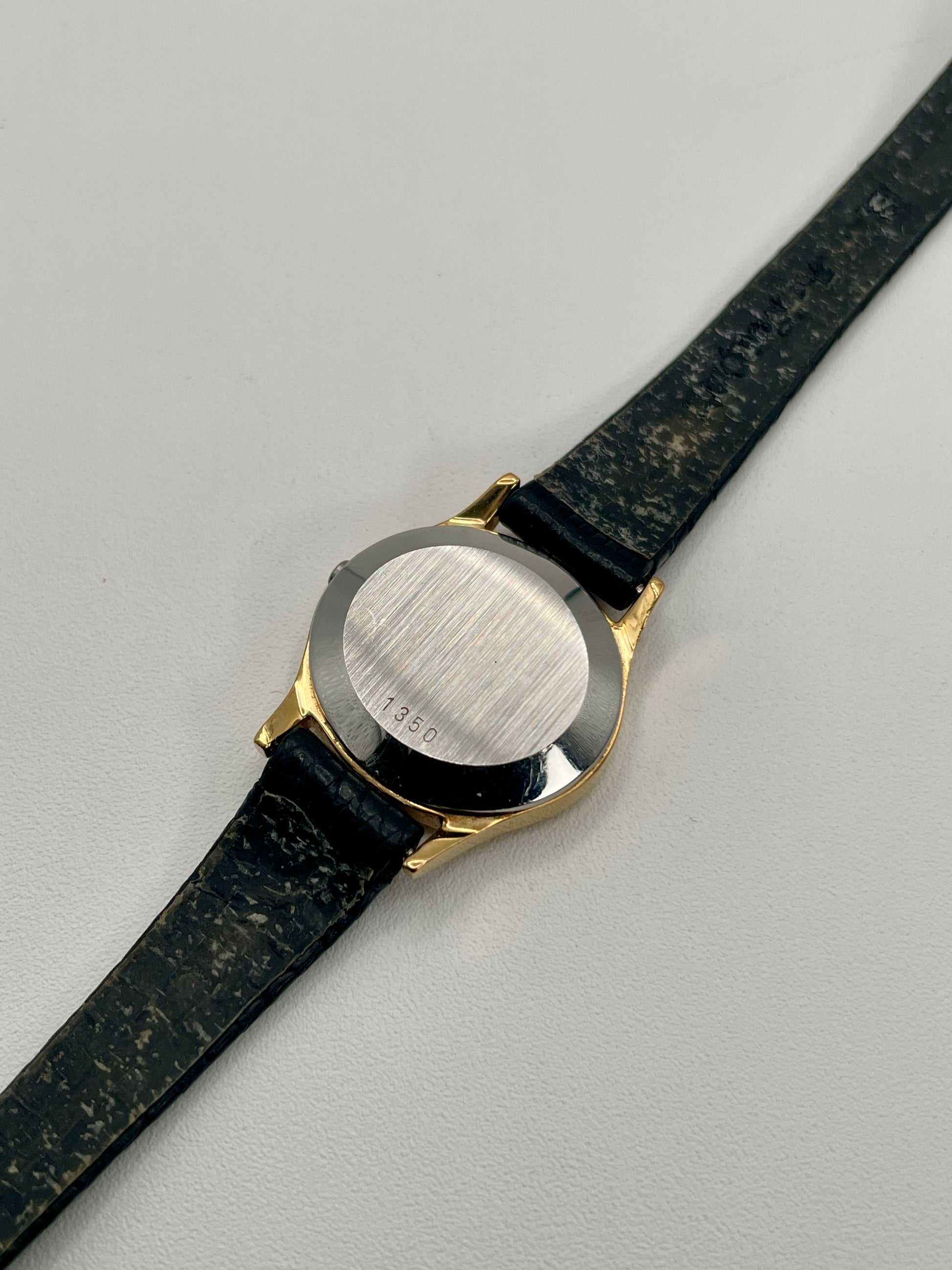 Close-up of the caseback of the Omega De Ville 1350 with brushed steel and serial engraving.