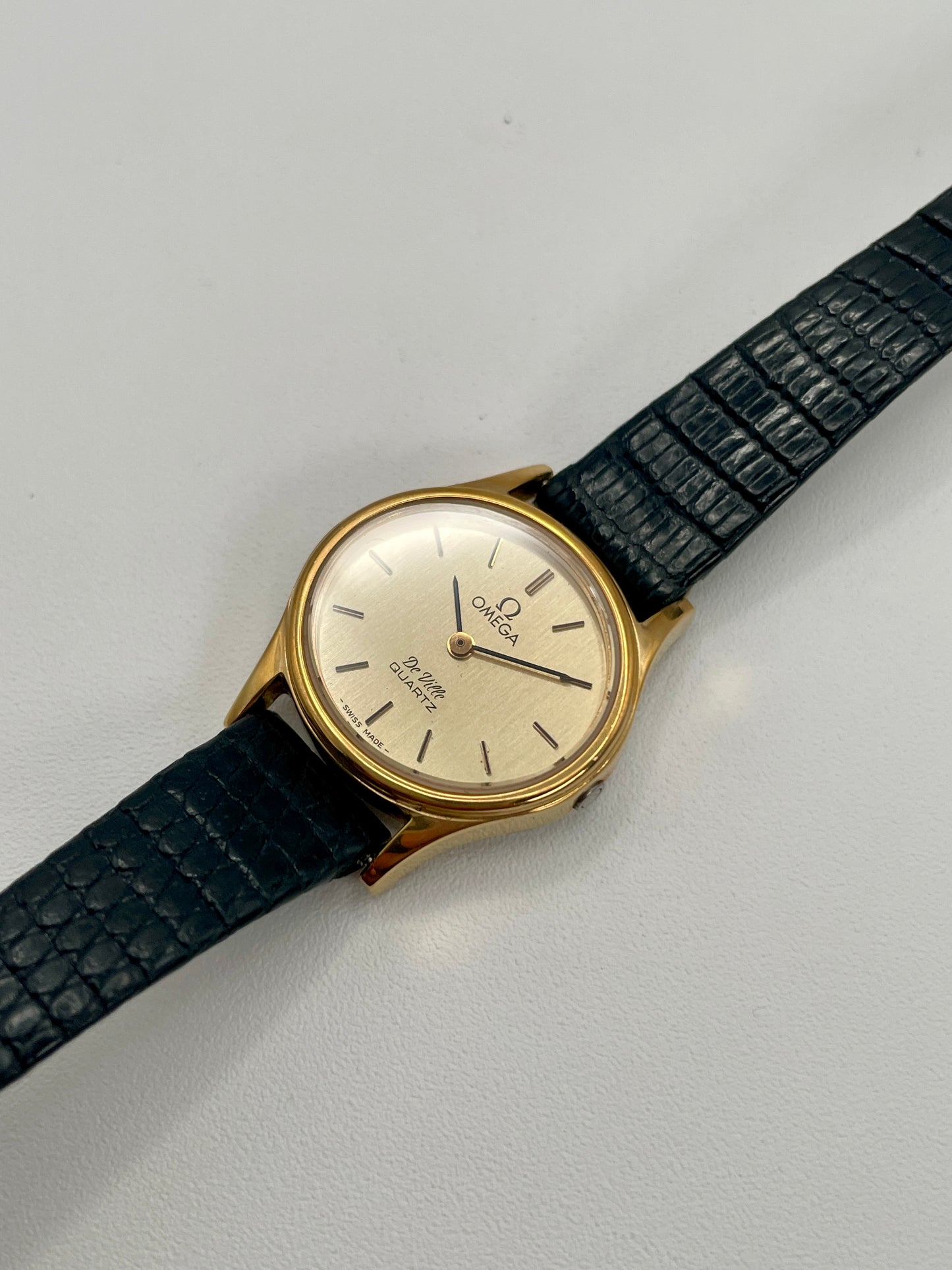 Diagonal angle showing the Omega De Ville 1350’s clean dial and polished gold-tone case.