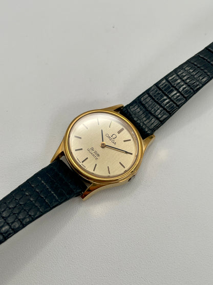 Diagonal angle showing the Omega De Ville 1350’s clean dial and polished gold-tone case.