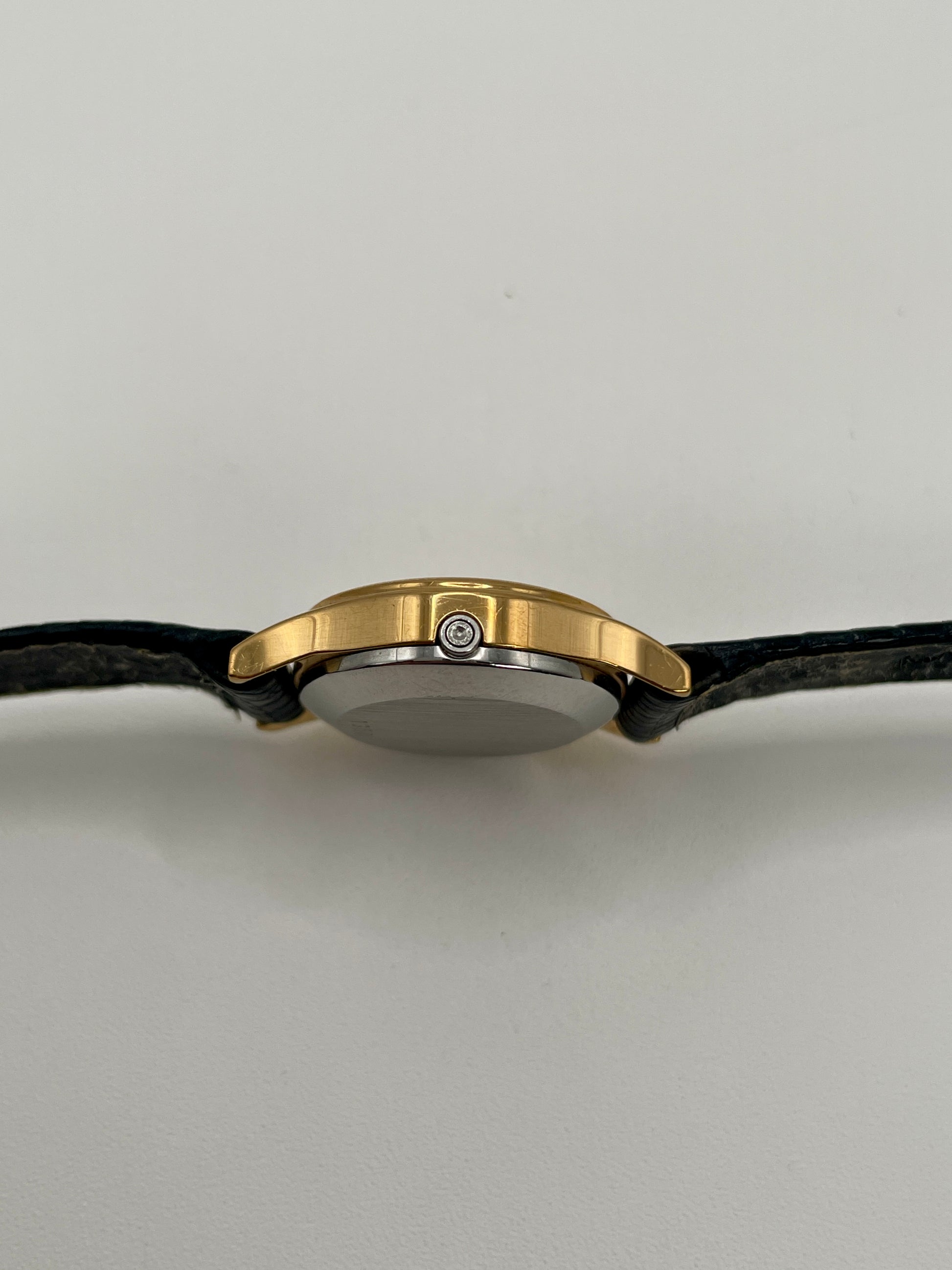 Side view showing the slim case and signed crown of the Omega De Ville 1350.